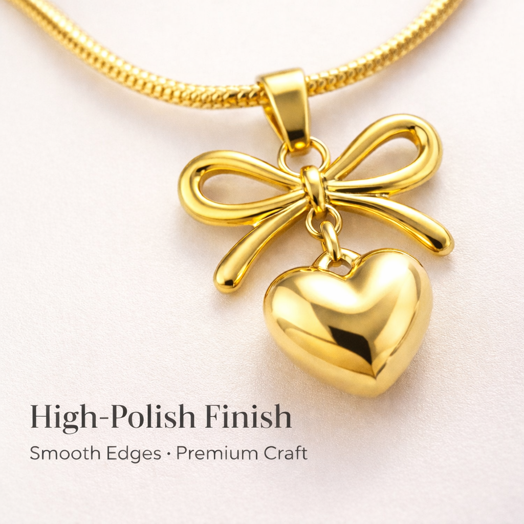 Close up view of gold bow and heart pendant necklace