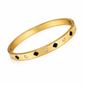 Gold bangle with clover motifs and crystal accents designed for daily styling