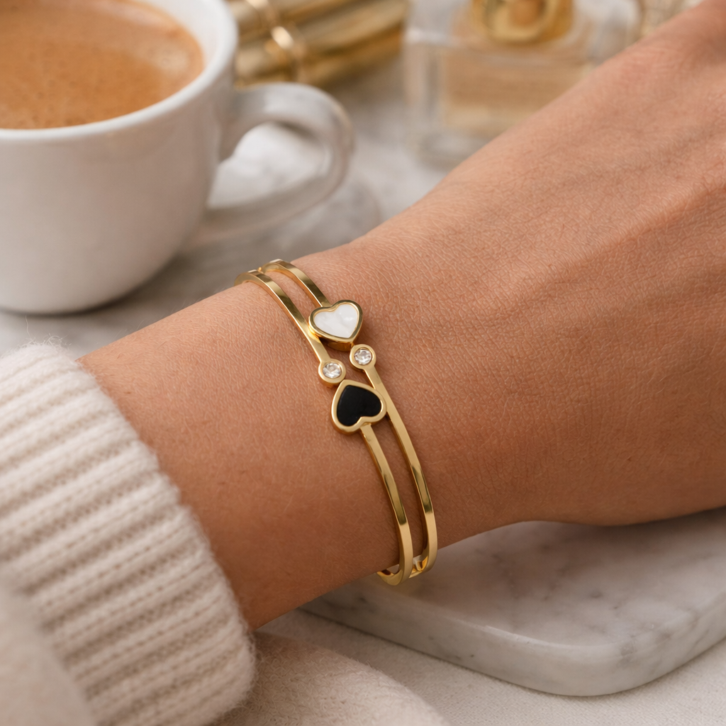 Woman wearing dual heart gold bracelet styled for everyday look
