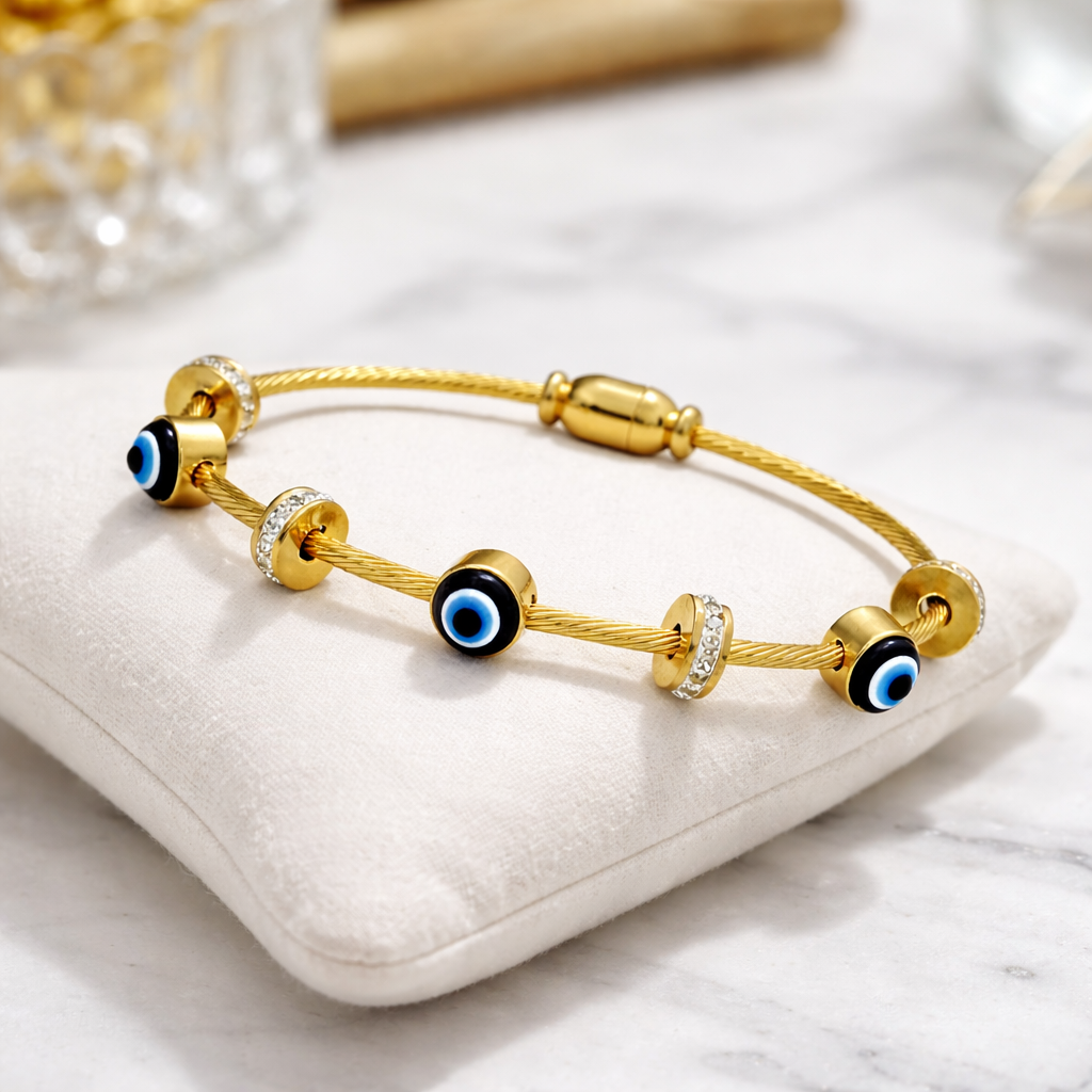 Angle view of evil eye charm gold plated bracelet