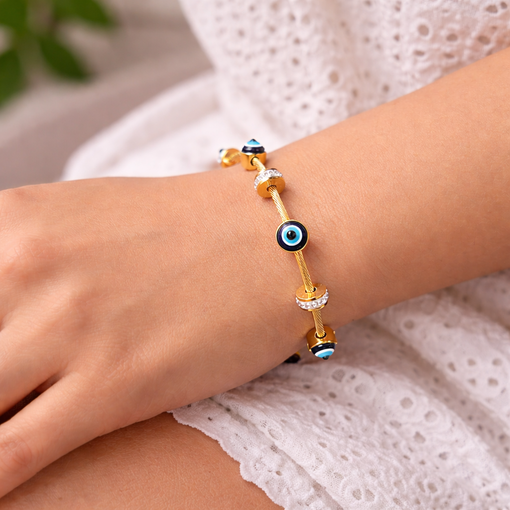 Woman wearing evil eye charm gold plated bracelet